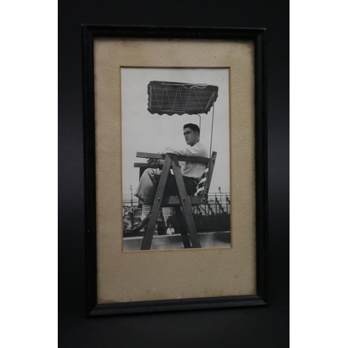 1122 - Black & white photograph of Ken umpiring in Milton QLD, frame approx 24cm x 16cm. Provenance: Ken Ro... 