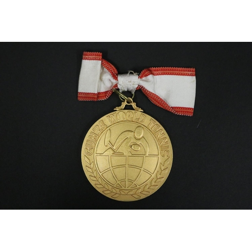 1320 - Tennis trophy medal. Inscribed, GUNZE WORLD TENNIS. WINNER 2ND GUNZE WORLD TENNIS 1975 23.24.25.NOV.... 
