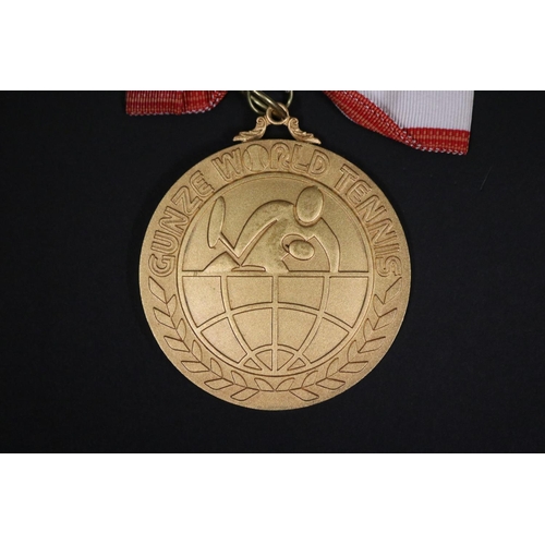 1320 - Tennis trophy medal. Inscribed, GUNZE WORLD TENNIS. WINNER 2ND GUNZE WORLD TENNIS 1975 23.24.25.NOV.... 