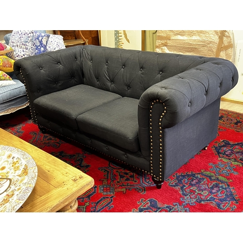 477 - Indigo  two seater chesterfield with studded trim to the front , approx 175cm W