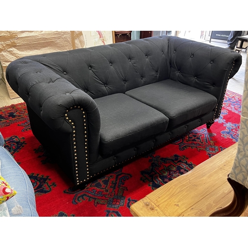 477 - Indigo  two seater chesterfield with studded trim to the front , approx 175cm W