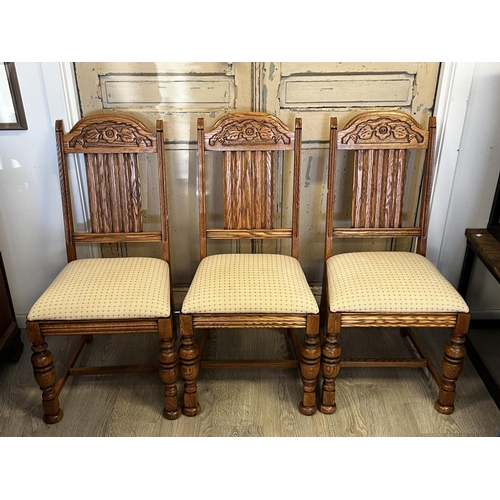 551 - Set of four American Oak turned leg dining chairs, to include one with arms  each with carved decora... 