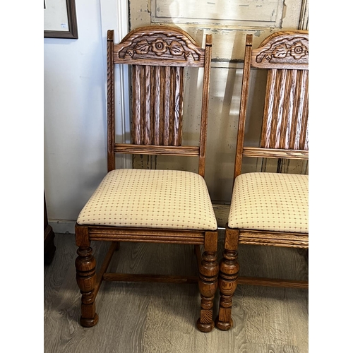 551 - Set of four American Oak turned leg dining chairs, to include one with arms  each with carved decora... 