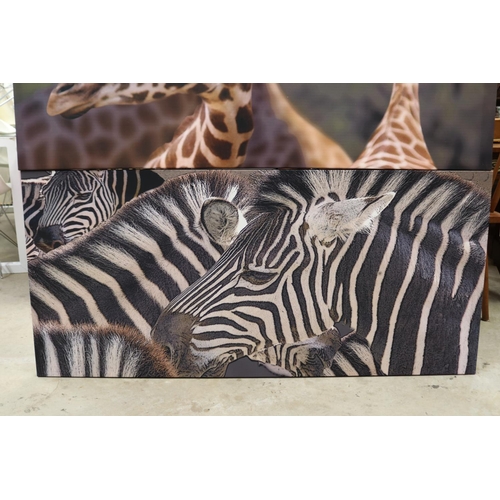 587 - Two decorative canvas's of a Zebra and Giraffe, approx 68cm x 147cm each (2)