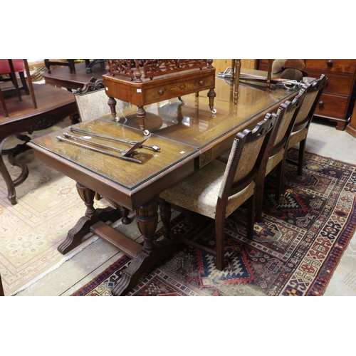 643 - English oak Tudor style dining suite - comprising a table with add on end table extensions. And matc... 