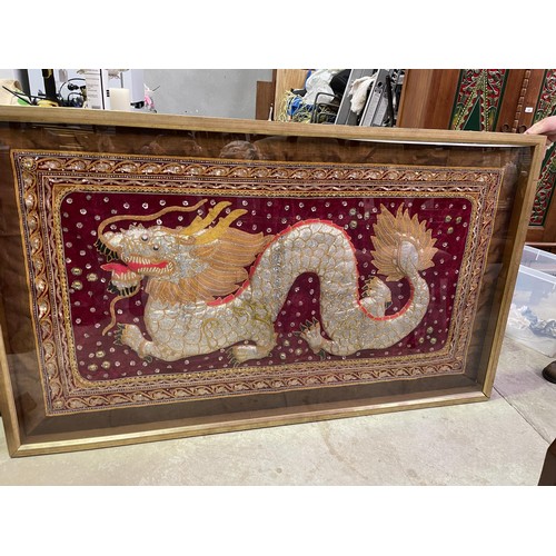 673 - Large Oriental shadow framed tapestry of a Dragon. approx 175 cm W, 101 cm H, 6 cm D.