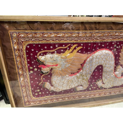 673 - Large Oriental shadow framed tapestry of a Dragon. approx 175 cm W, 101 cm H, 6 cm D.