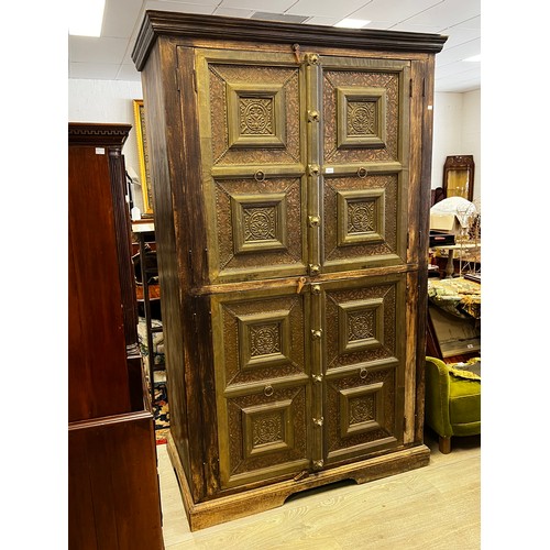 736 - Large Indian four door cabinet, with applied stepped brass framed panels and applied bosses, approx ... 