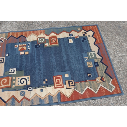 57 - Handwoven blue ground carpet, approx 171cm x 231cm