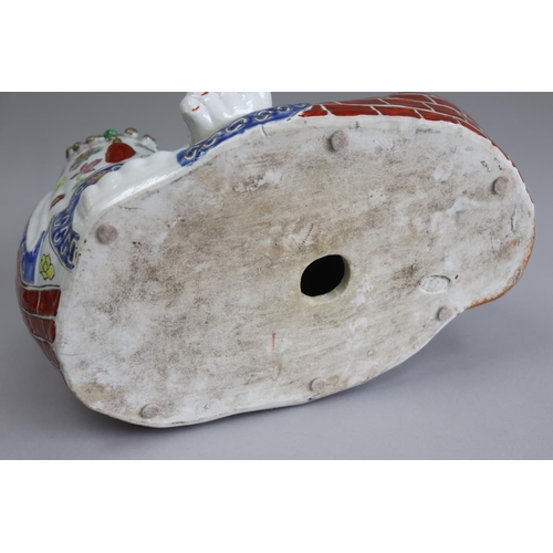 83 - Large Chinese porcelain seated lucky 'Hotei' with enamelled decoration, approx 30cm H x 33cm W x 24c... 