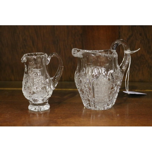 137 - Two small crystal jugs in star pattern, approx 9cm H x 10cm W and smaller