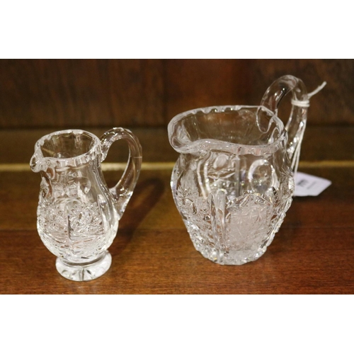 137 - Two small crystal jugs in star pattern, approx 9cm H x 10cm W and smaller