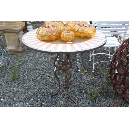 124 - Tiled top circular garden table with wrought iron base, approx 79cm H x 80cm Dia