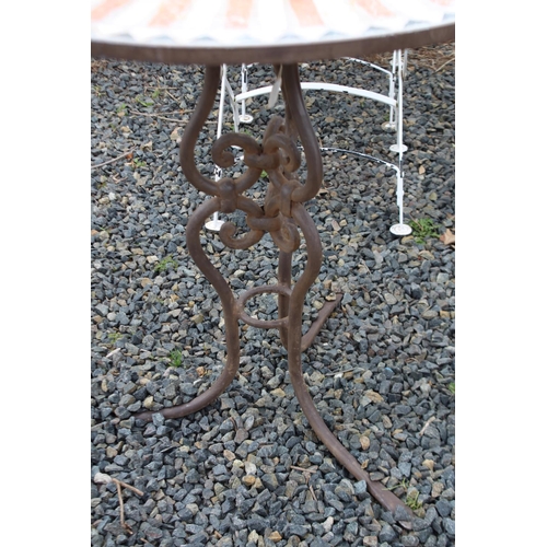 124 - Tiled top circular garden table with wrought iron base, approx 79cm H x 80cm Dia