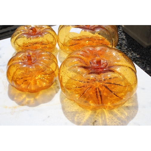 128 - Five amber glass pumpkins, approx 21cm Dia and smaller (5)  please note an extra one has been added ... 
