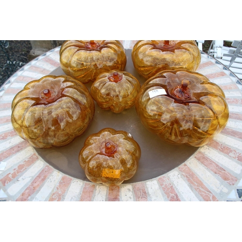 129 - Six amber glass pumpkins, approx 21cm Dia and smaller (6)