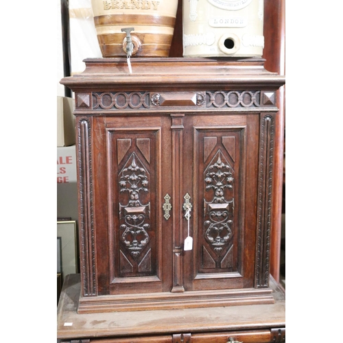 462 - A late 19th century Continental walnut side cabinet, fitted with four carved and panelled doors, the... 