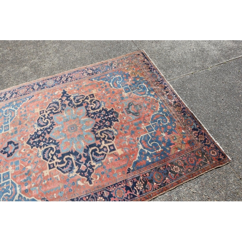 87 - Semi antique village weave hand knotted wool carpet, with central blue medallion. Approx 340 L x 258... 
