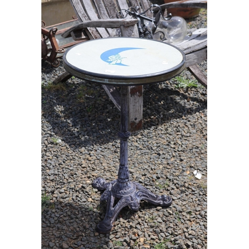 133 - French cast iron based café table, blue moon and Pierrot to the top, approx 76cm H x 51cm Dia