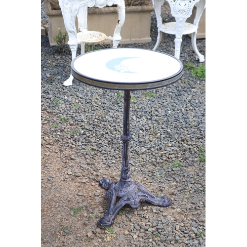 134 - French cast iron based café table, blue moon and Pierrot to the top, approx 76cm H x 51cm Dia