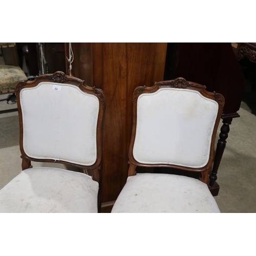 599 - Pair of antique French carved walnut side chairs in the Louis XV style (2)