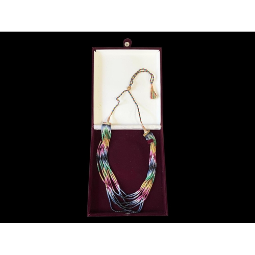 152 - Contemporary Eastern necklace, 9 strands of semi precious multi stones that make an IKAT design, on ... 