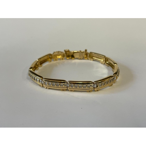 154 - 18ct yellow and white gold train bracelet. Purchased on the Venice Simplon Orient Express on a Journ... 