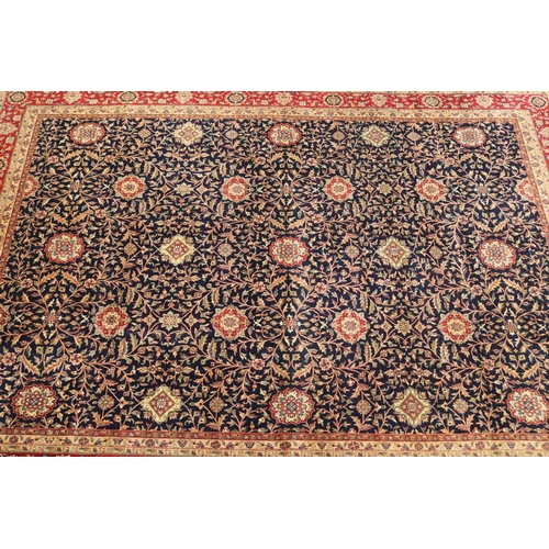 221 - Fine hand knotted wool Persian carpet, with central royal blue field with all over flower heads and ... 