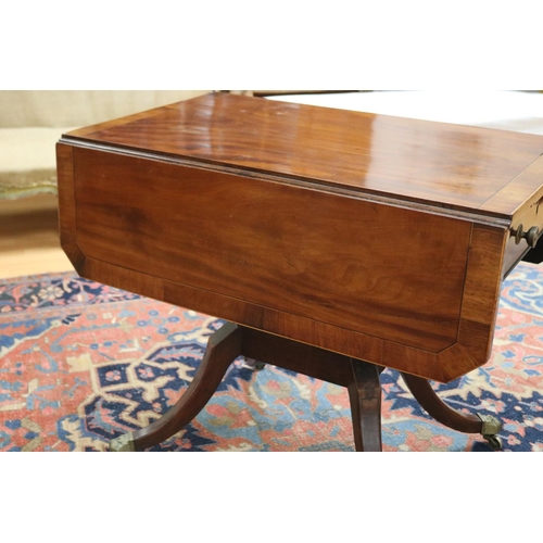 139 - Antique late George III mahogany sofa table, the twin flap rectangular top with canted corners cross... 