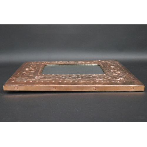 187 - Arts & Crafts embossed copper framed mirror, approx 38cm x 42cm