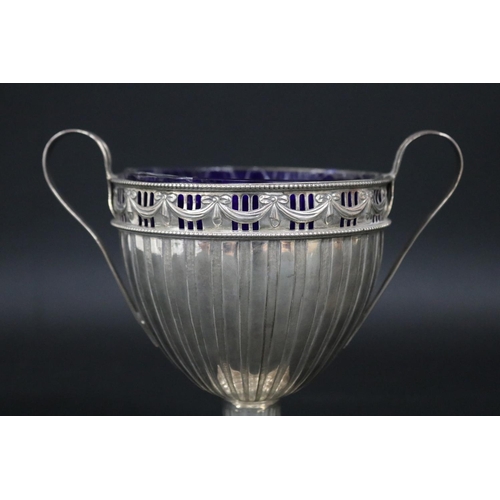 121 - Sterling silver pedestal twin handled cup, approx 15cm H x 17cm W and approx 315 grams excluding gla... 