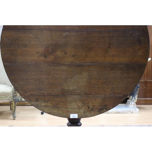 101 - Antique George III oak tripod table, the circular tilt-top on turned baluster pedestal and three swe... 