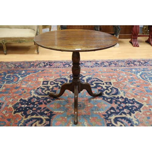 101 - Antique George III oak tripod table, the circular tilt-top on turned baluster pedestal and three swe... 