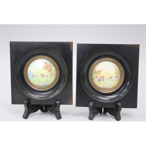 553 - Pair of circular miniature hunting scenes in ebonized frames, each approx 12cm Sq frame size (2)