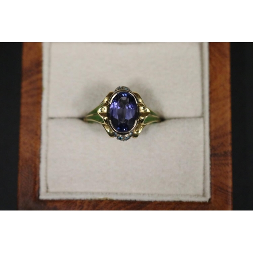 164 - 18ct gold antique style enamelled dress ring set with an oval cut tanzanite approx 2 carats, in orig... 