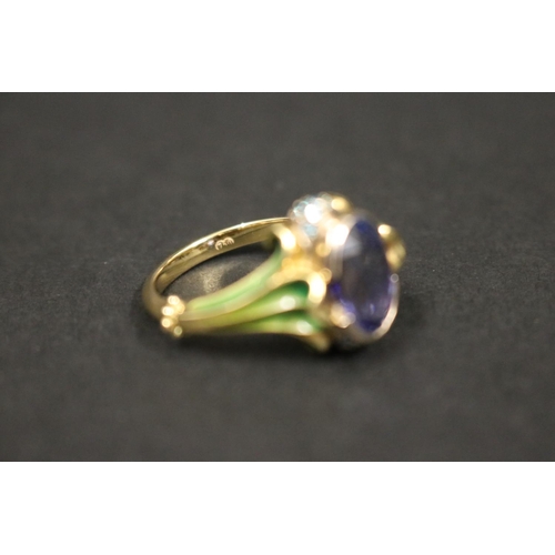 164 - 18ct gold antique style enamelled dress ring set with an oval cut tanzanite approx 2 carats, in orig... 