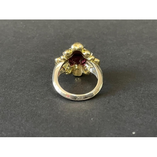 165 - 9ct and 18ct yellow and white gold flower design dress ring set with a large centre red stone and fo... 