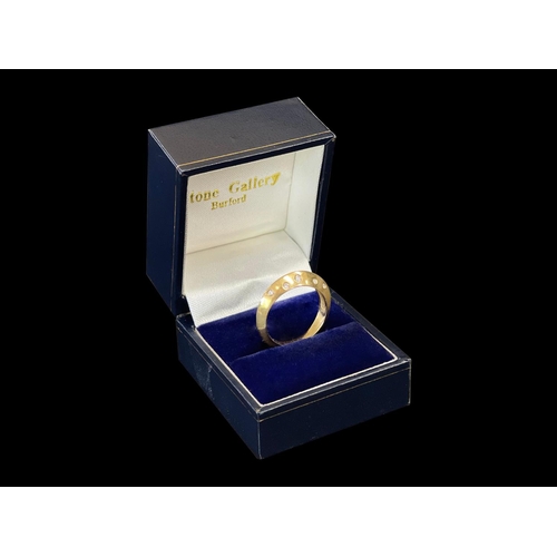 168 - 18ct yellow gold modern knife edge design ring set with 10 small diamonds, in original box. English ... 