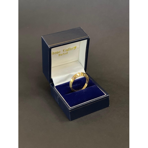 168 - 18ct yellow gold modern knife edge design ring set with 10 small diamonds, in original box. English ... 