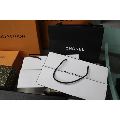 588 - Assortment of empty designer bags to include Louis Vuitton, Chanel, etc