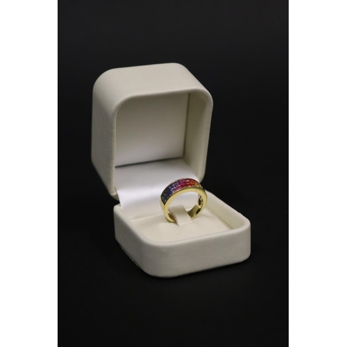 166 - 18ct yellow gold ring set with Parti coloured sapphires in a rainbow pattern, in original box. Purch... 