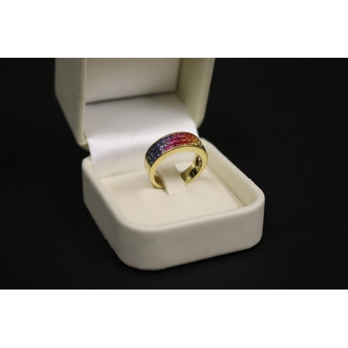 166 - 18ct yellow gold ring set with Parti coloured sapphires in a rainbow pattern, in original box. Purch... 