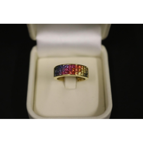 166 - 18ct yellow gold ring set with Parti coloured sapphires in a rainbow pattern, in original box. Purch... 