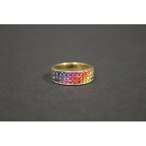 166 - 18ct yellow gold ring set with Parti coloured sapphires in a rainbow pattern, in original box. Purch... 