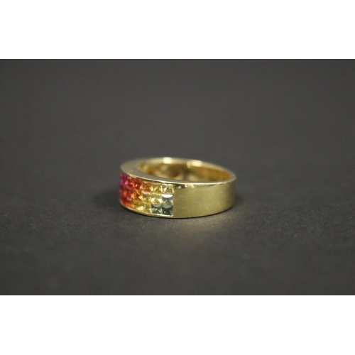 166 - 18ct yellow gold ring set with Parti coloured sapphires in a rainbow pattern, in original box. Purch... 