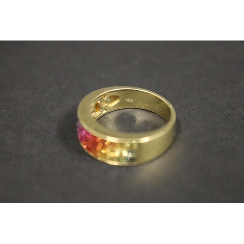 166 - 18ct yellow gold ring set with Parti coloured sapphires in a rainbow pattern, in original box. Purch... 