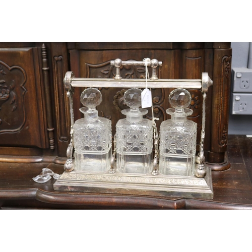 133 - Antique English tantalus with three decanters, AF to one decanter, approx 32cm H x 38cm W