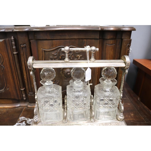 133 - Antique English tantalus with three decanters, AF to one decanter, approx 32cm H x 38cm W