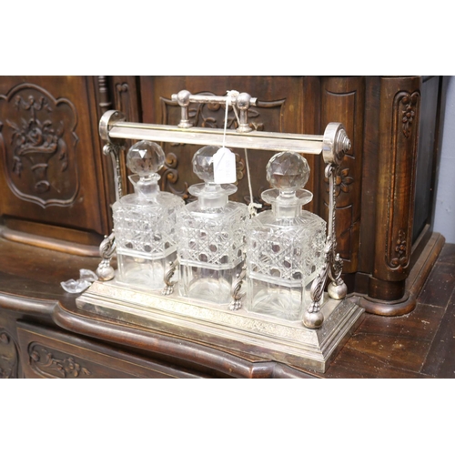 133 - Antique English tantalus with three decanters, AF to one decanter, approx 32cm H x 38cm W