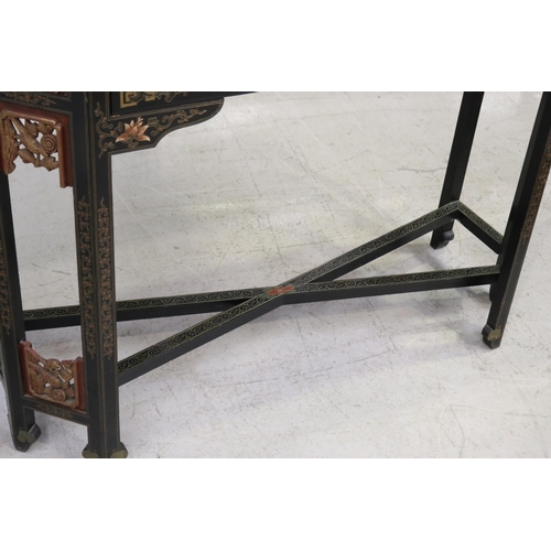 598 - Oriental hall table with two drawers. with chamfered gilt corners, each woth detailed carvings and c... 